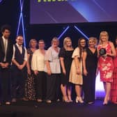 Executive headteacher Nicky Donley (holding the award) and staff collecting the award on behalf of the whole school, pictured with host Richard Ayoade.