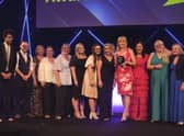 Executive headteacher Nicky Donley (holding the award) and staff collecting the award on behalf of the whole school, pictured with host Richard Ayoade.