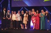 Executive headteacher Nicky Donley (holding the award) and staff collecting the award on behalf of the whole school, pictured with host Richard Ayoade.