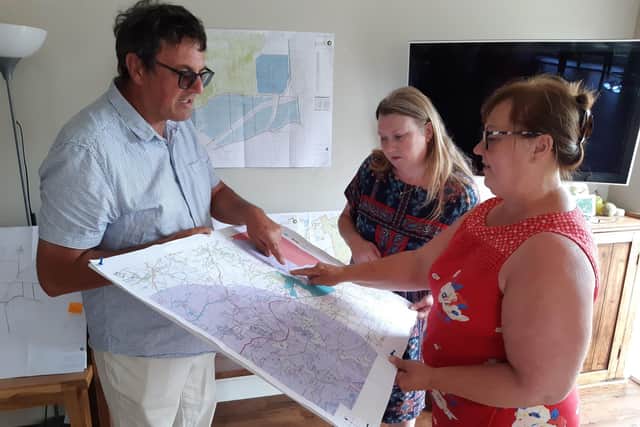 Hatton villagers Nigel Howorth, Tracey Capel and Mandy Howorth study the solar farm plans.