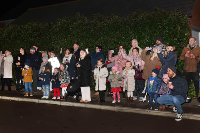 Crowds watch the switch-on of the family's Christmas lights. Photos by Mick Fox.