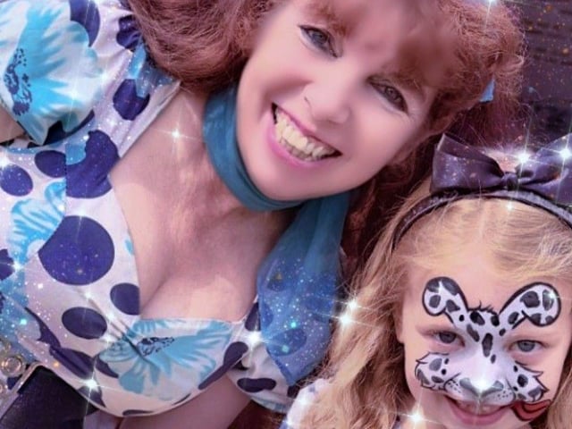 Dee' Dee Lee as Alice'Dee and a competition winner playing "Little Alice," at the Alice in Wonderfarm at the weekend.