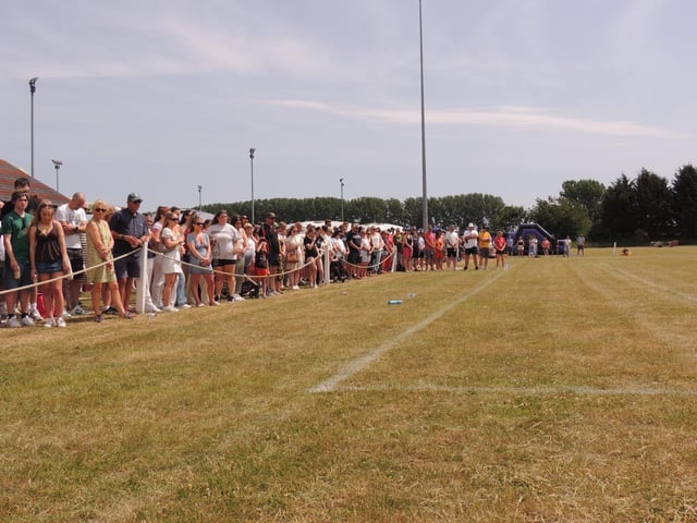 Spectators pause for a minute's silence in memory of Will Ray and Eddie Shore.