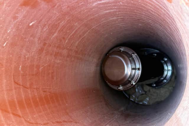 The time capsule, in the hole, ready to be buried