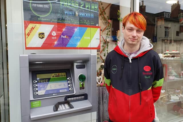 Sleaford Postmaster Lee Taylor and the new, free-to-use cash machine installed at the indoor market on Southgate.