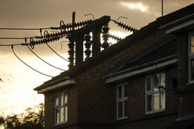 An electricity sub station pylon stands next to a home in England. (Photo by Christopher Furlong/Getty Images)
