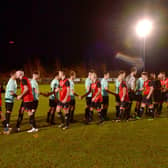 A handshake before kick off. Fire Service (red) v RAF Red Arrows (blue).