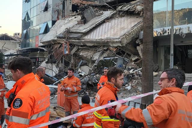 UK rescue crews outside the collapsed hotel in Antakya where a man and woman were pulled out alive. Photo: Colin Calam