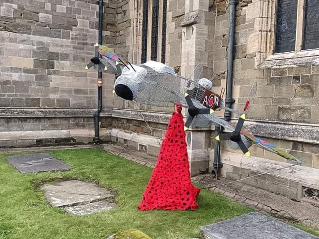 Poppies falling from a 18ft Lancaster model outside St Wilfrid's Church in Alford.