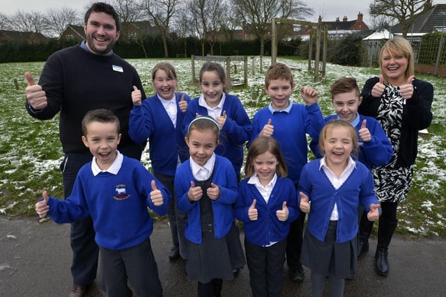 Celebrations at Tetney Primary School, where the National Lottery's Big Lotto Fund had awarded money to re-vamp an outdoor play area. A multi-activity timber adventure trail was set to be installed. Pupils are pictured in front of the old play area with teacher Tom Hawkins and headteacher Helen Carter.