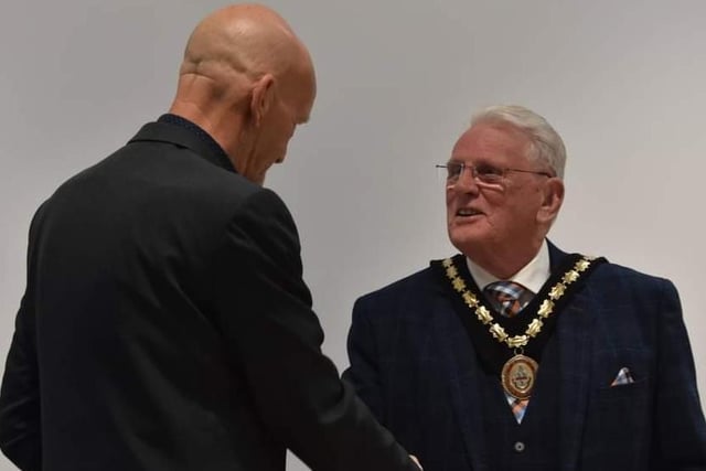 Outgoing Mayor Trevor Burnham hands over the chain of office to Coun Tony Tye.