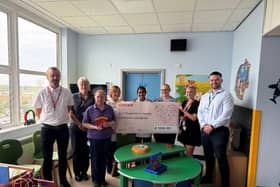 Coveris employees present a £1,000 donation to representatives at Pilgrim Hospital’s Children’s Ward. Mark Ellis – Enterprise Way site manager; left and Leah Bretten- HR Advisor, second to the right.