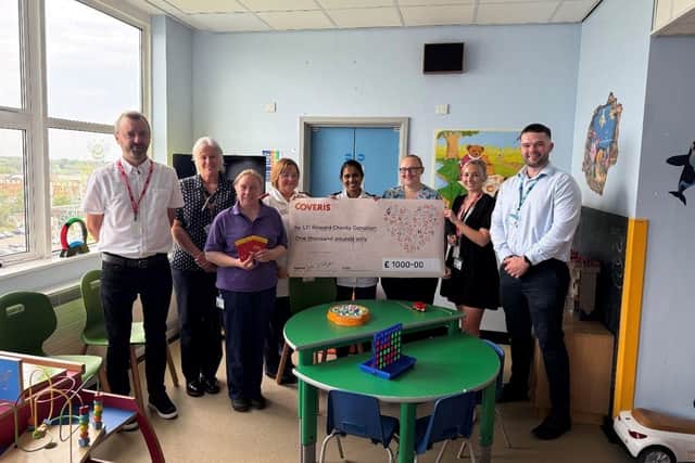 Coveris employees present a £1,000 donation to representatives at Pilgrim Hospital’s Children’s Ward. Mark Ellis – Enterprise Way site manager; left and Leah Bretten- HR Advisor, second to the right.
