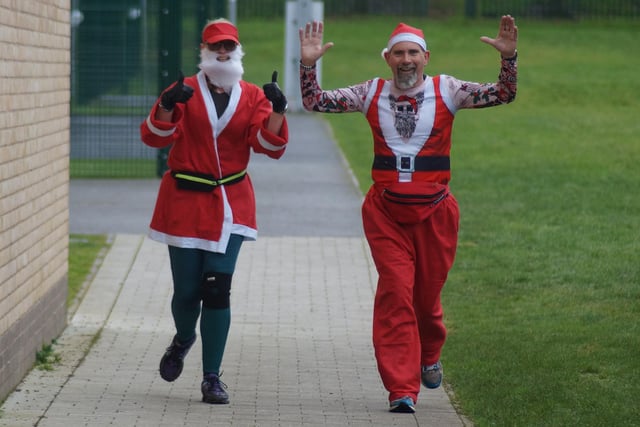 Thumbs up as these Santas complete the course
