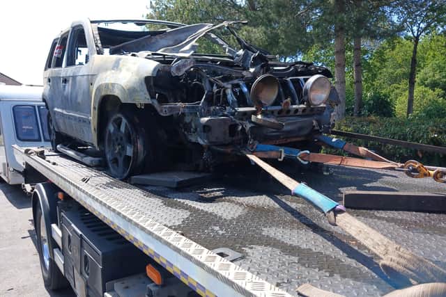 The burnt out shell of the Jeep being taken away by a recovery firm. Photo: Terry Madley