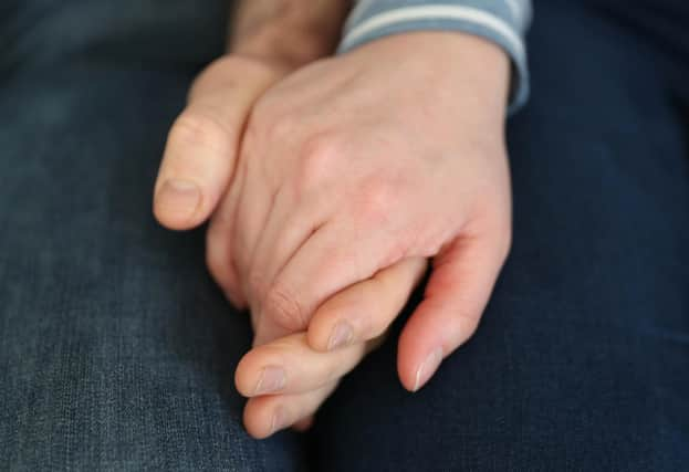 File photo dated 05/02/20 of a married couple holding hands, as couples could receive financial support from their partners if relationships break down, a report aimed at reforming the law for cohabiters in Scotland has suggested.