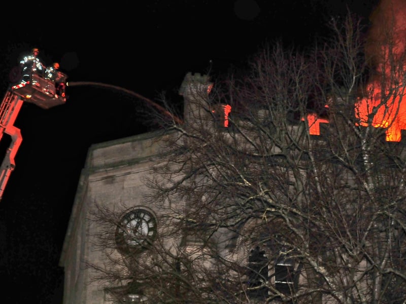 Firefighters pour water onto the flames on the roof of the Sessions House. Photo: Roderick Carlyle