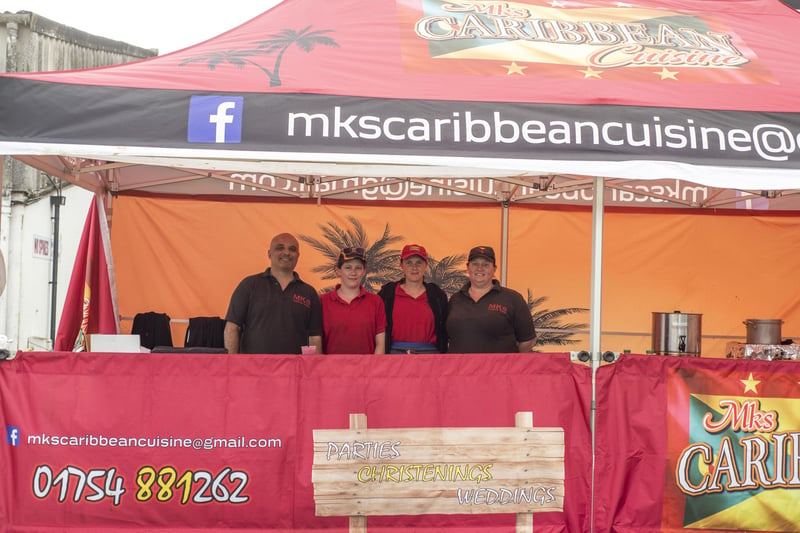 Serving up some delicious Food are MKs Caribbean Cuisine staff.