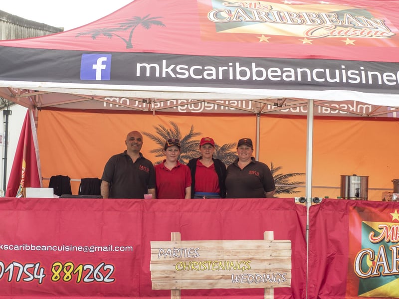 Serving up some delicious Food are MKs Caribbean Cuisine staff.