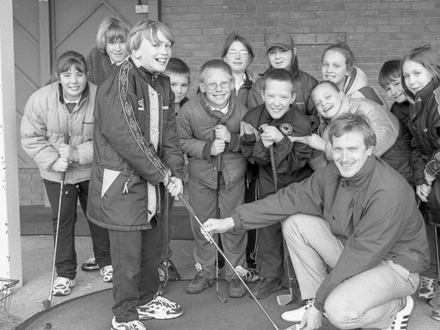 Youngsters from Park Primary School, Boston, paying a visit to Boston West Golf Centre. Professional Andrew Hare is pictured alongside pupil Toby Williamson and classmates at the centre's driving range.