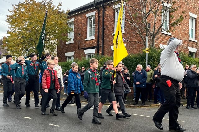 Representatives from the Scouts march in the parade.