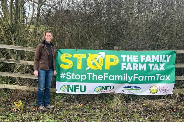 Farmer Amy Jobe with a banner on farm Louth