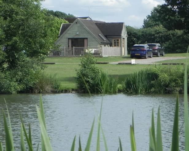 The Skylark Lodge at Brook Meadow viewed from across the campsite's five-acre fishing lake