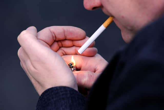 PICTURE POSED MY MODEL: A general view of a man smoking a cigarette.