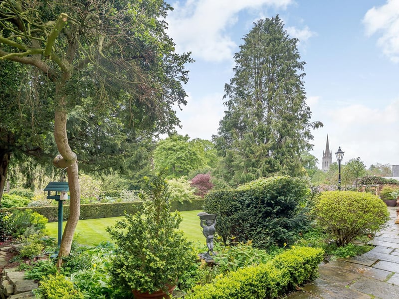 The garden includes two lawns, a summer house, a second garage/log store, paved terracing, box hedging, colourful flowerbeds and a variety of mature shrubs and trees.