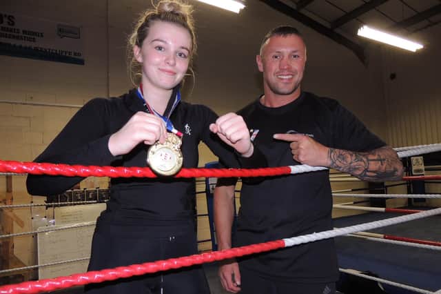 New champ. Emmie O'Leary, 16, with boxing trainer Amir Unsworth.