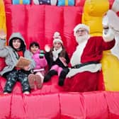Youngsters enjoy a ride on Santa's inflatable sleigh with the great man himself at Mablethorpe's Christmas market.