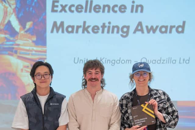 Jasmine Kent (right) and Harry Hinkley (centre), of Quadzilla Ltd, receive the CFMOTO global marketing excellence award.
