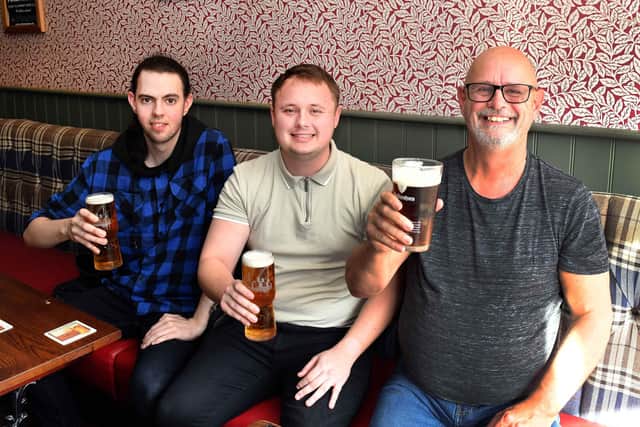Matthew Williams, Tom Walker and John Walker cheer on the Mariners in the Pack Horse, Louth.