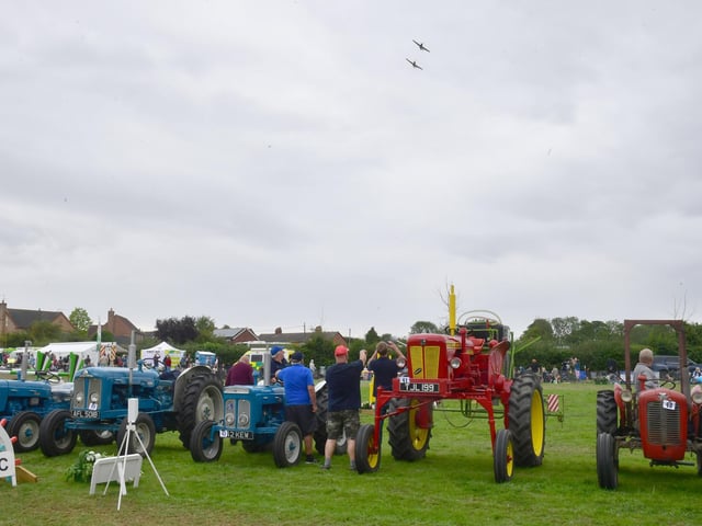 Spitfire Flypast over the vintage tractor drive in the main ring.