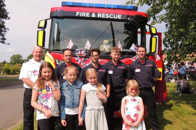 Children meet Brant Broughton fire crew at the jubilee party and parade.