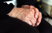 File photo dated 07/10/13 of the hands of an elderly woman at home. Councils are struggling to meet rising requests for adult social care support and some people are cutting back on their home care amid the cost-of-living crisis while "completely overwhelmed" family carers try to fill the gaps, the health watchdog has said. Issue date: Friday October 20, 2023.