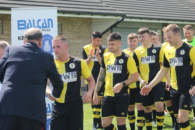 The Colts line up to collect their trophies.