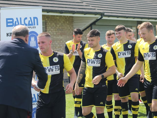 The Colts line up to collect their trophies.