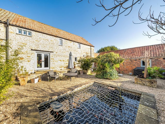 The courtyard garden and entrance to the home in the background.