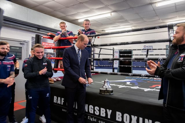 HRH The Prince of Wales rings the bell of the RAF Coningsby boxing gym.