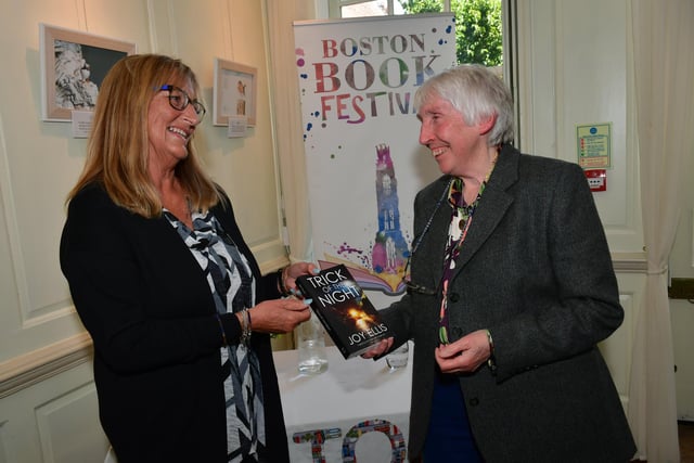 Bridget Deptford, of Boston, talking to author Joy Ellis, right.