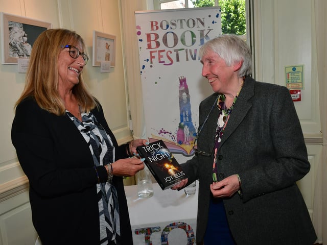 Bridget Deptford, of Boston, talking to author Joy Ellis, right.