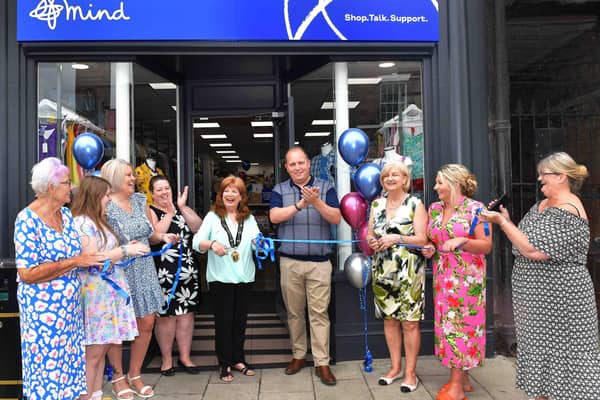 Mayor Coun Julia Simmons (centre) opens the new Mind shop with regional manager Keven Willows (third right). Photo: Mick Fox