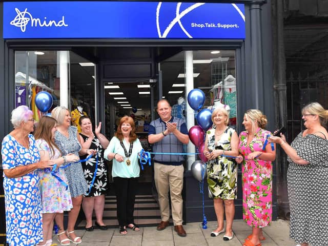 Mayor Coun Julia Simmons (centre) opens the new Mind shop with regional manager Keven Willows (third right). Photo: Mick Fox