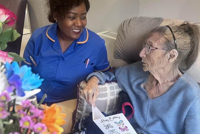 Registered General Nurse Rhoda Mlauzi and resident Irene Hammond at Elmwood House Care Home