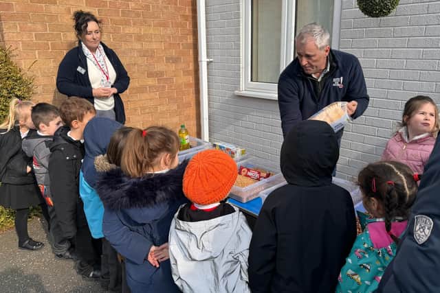 Farmer Andrew Ward brought lambs in to show the pupils at Redwood Primary School. Photo: LAS