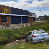 A car in the ditch next to the new McDonald's off the A52 near Tesco.