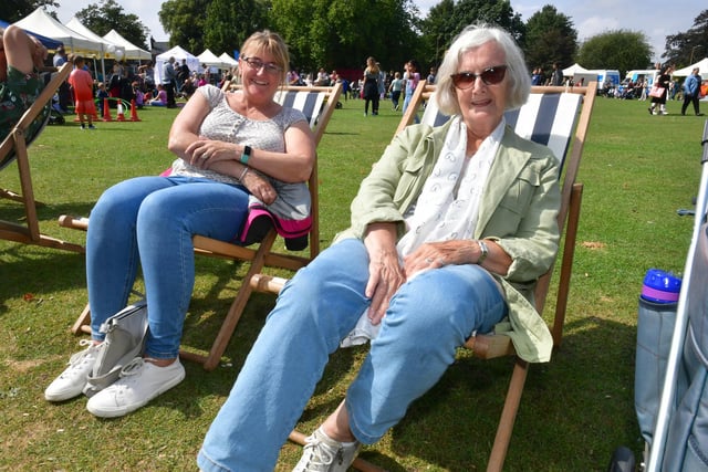 Lisa Chalk and Barbara Newham of Boston relax on some traditional deck chairs at the beach event.