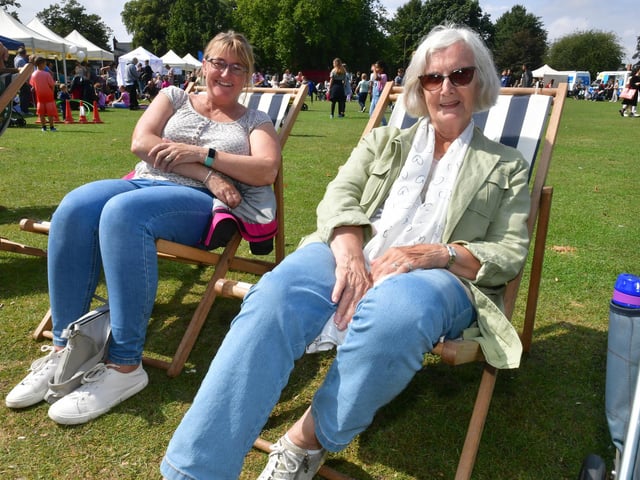 Lisa Chalk and Barbara Newham of Boston relax on some traditional deck chairs at the beach event.