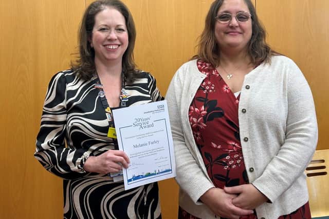 Melanie Farley receiving her Long Service Awards certificate at the celebration event